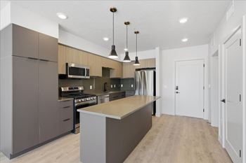 Modern kitchen with large island in the middle with pendant lights1